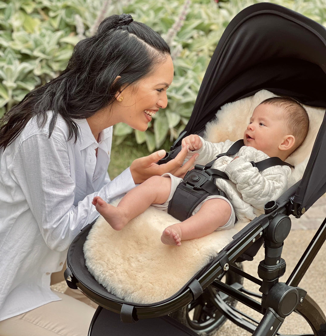 Milk sheepskin pram and buggy liner fitting perfectly in a  cybex priam pram with happy baby comfortable in the summer 