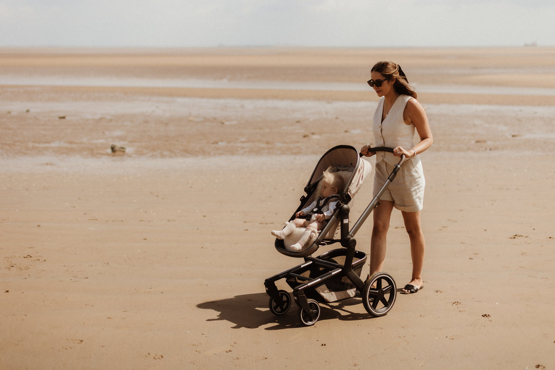 sheepskin liner in an egg pram on a hot day on the beach