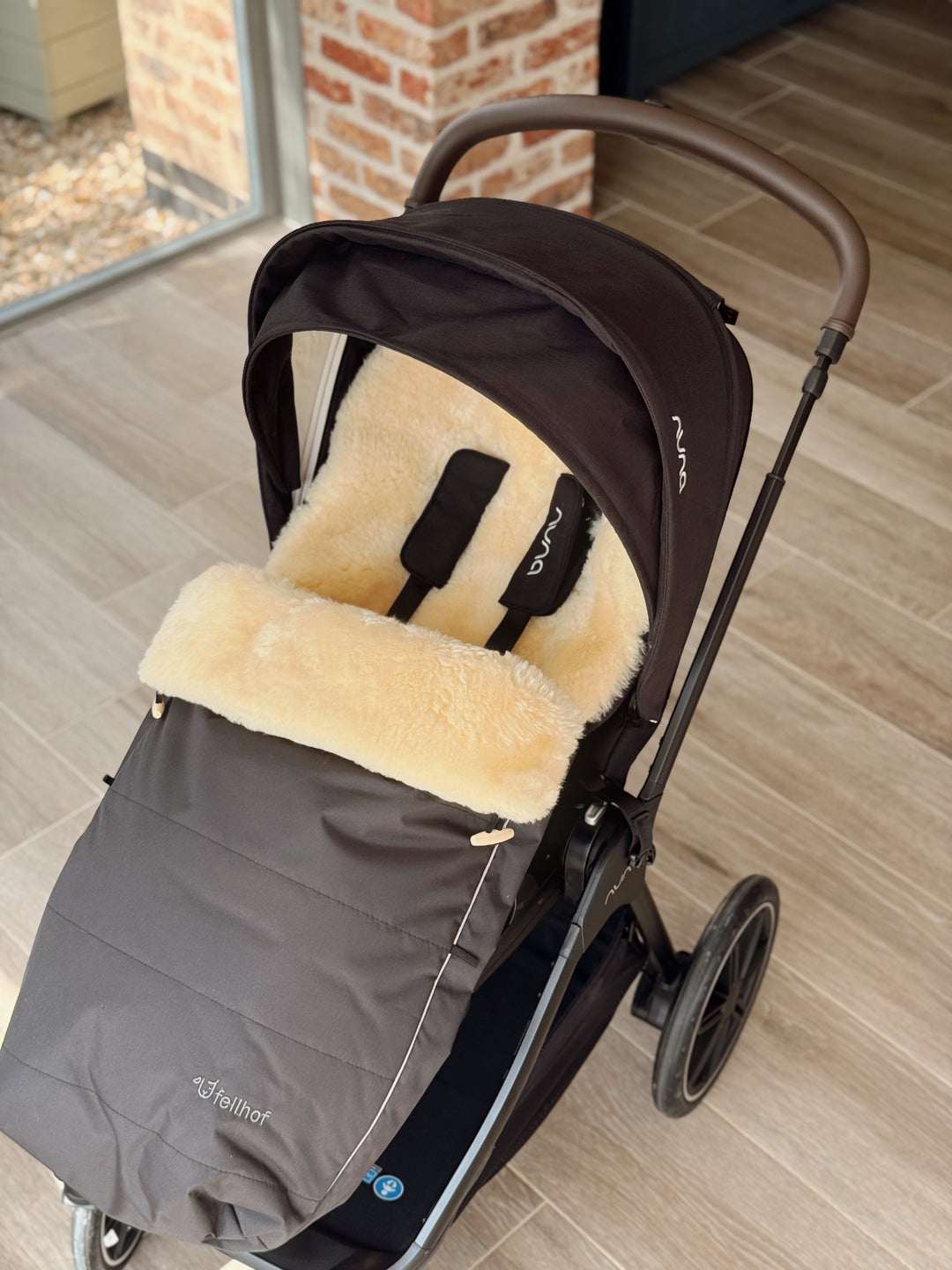 Fellhof sheepskin pram footmuff in the Nuna Triv buggy