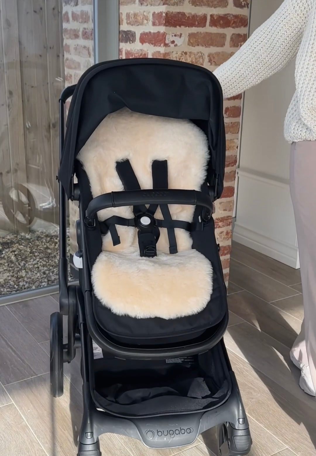 Sheepskin pram liner in bugaboo fox 5 buggy to comfort and settle baby on walks