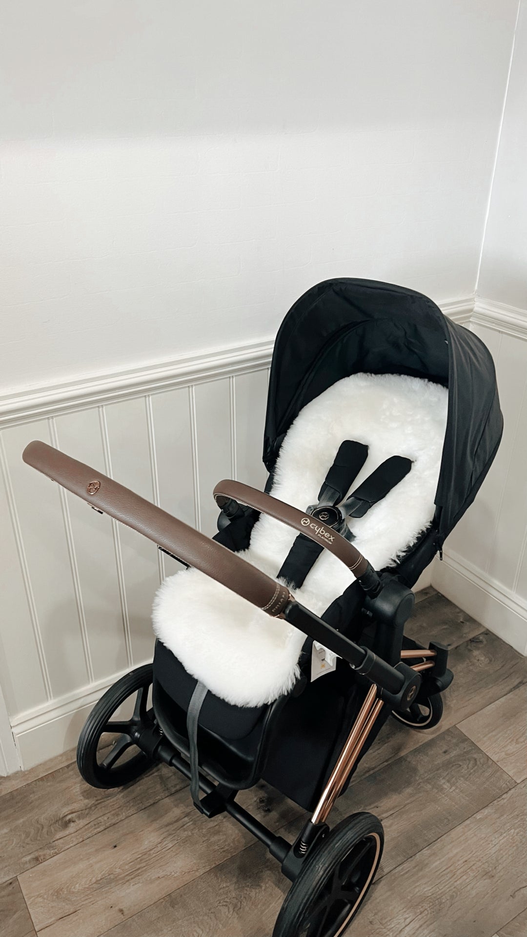 Sheepskin buggy liner in a cybex priam pram