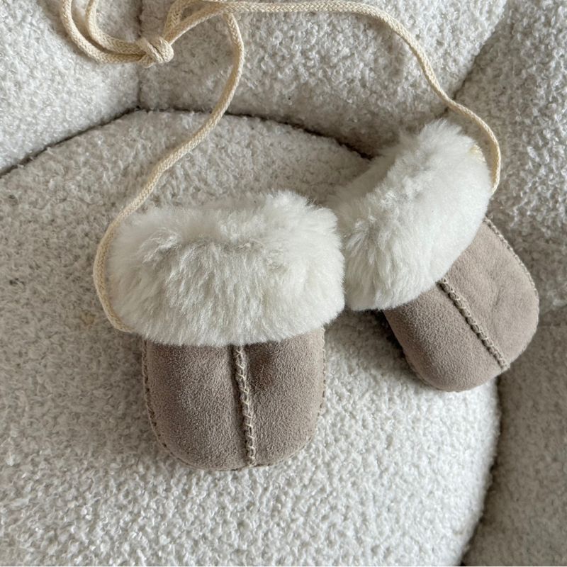 sheepskin puddy mittens on string in a neutral pebble colour