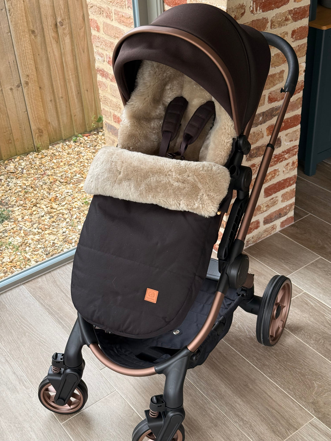 Sheepskin footmuff in soft beige shown in a iCandy Peach Pram