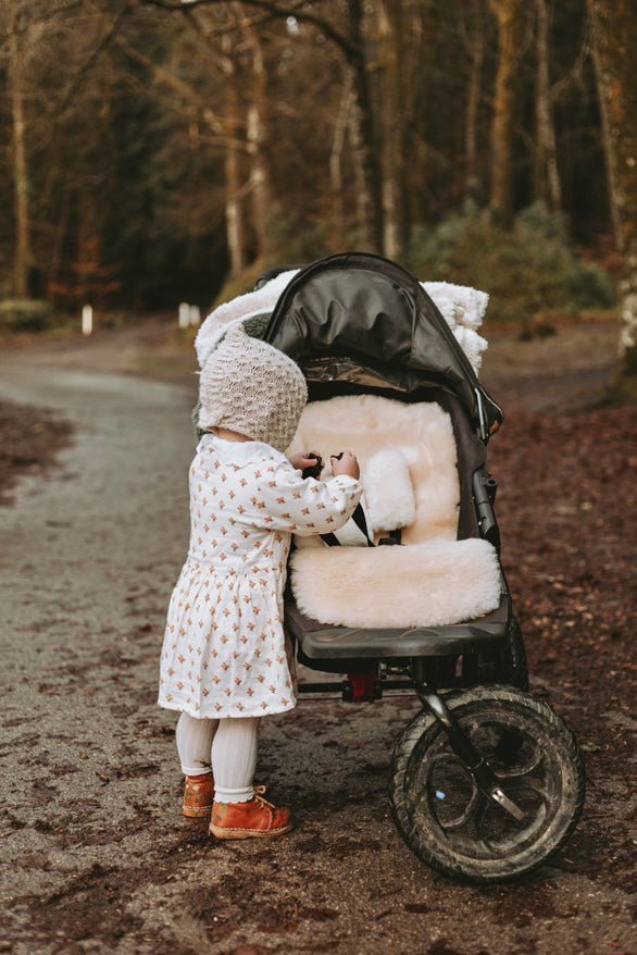 Sheepskin pram liner shown in an mountain buggy pram