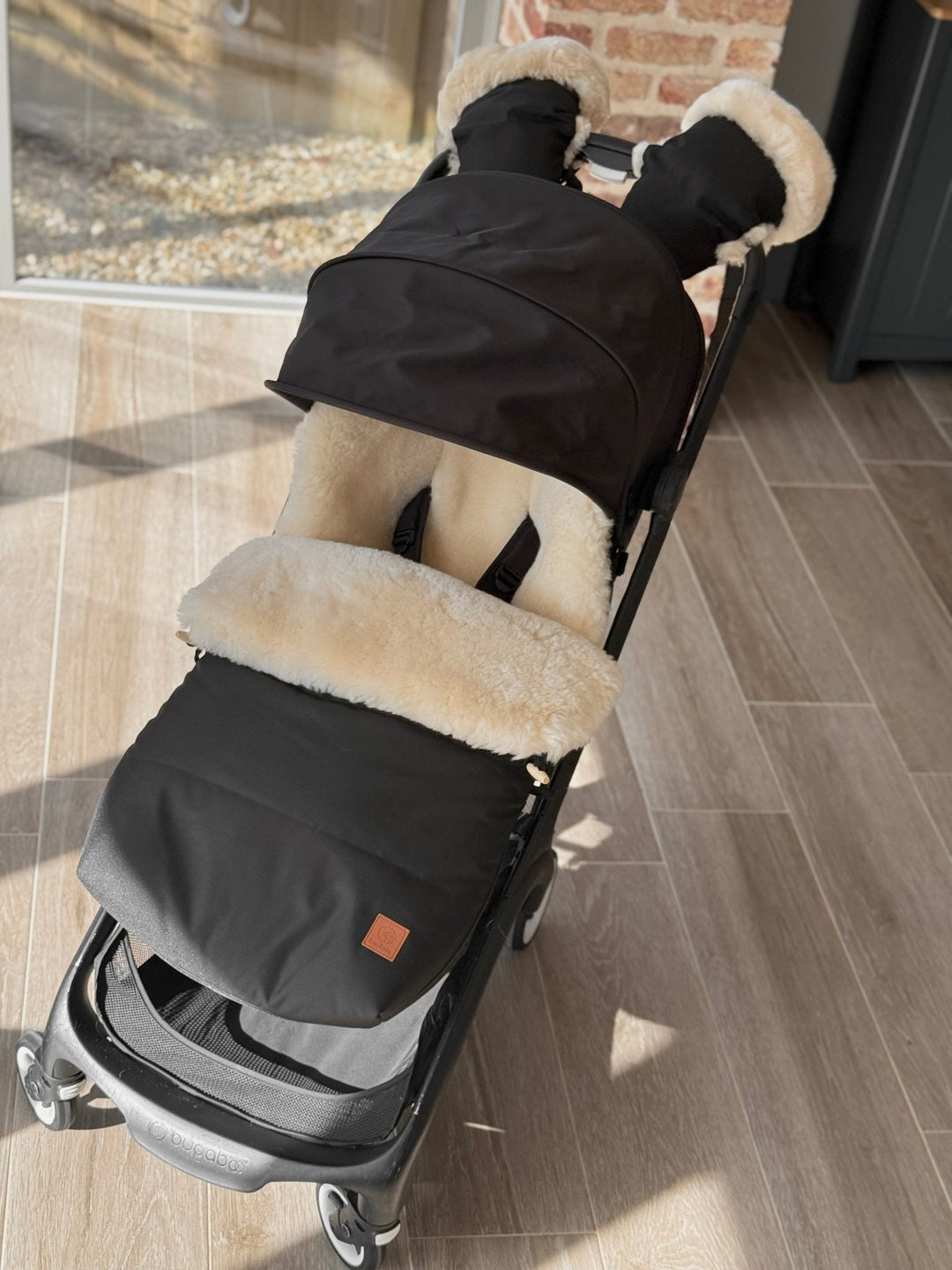 Sheepskin pram footmuff in a bugaboo butterfly stroller