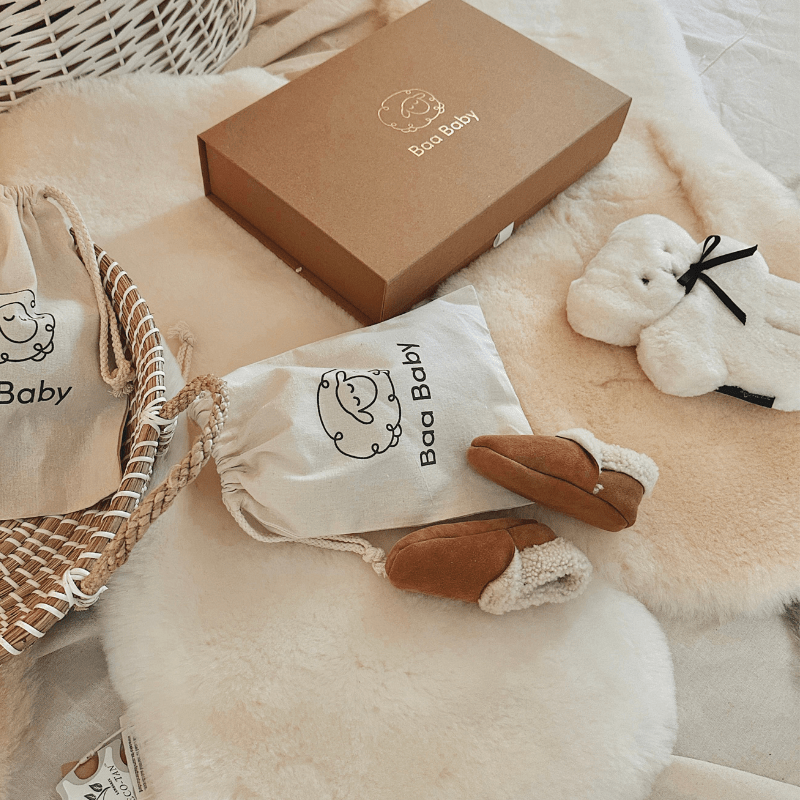 Luxury sheepskin baby products ideal for gifting including a flat sheepskin newborn teddy bear, sheepskin pram liners sheepskin rugs and a luxury baby shower gift box