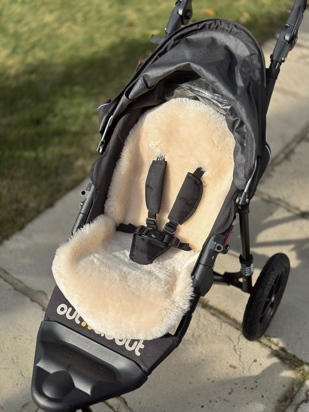 Sheepskin Snuggler Liner Showing how well it fits in an Out n About Nipper three wheeled pram