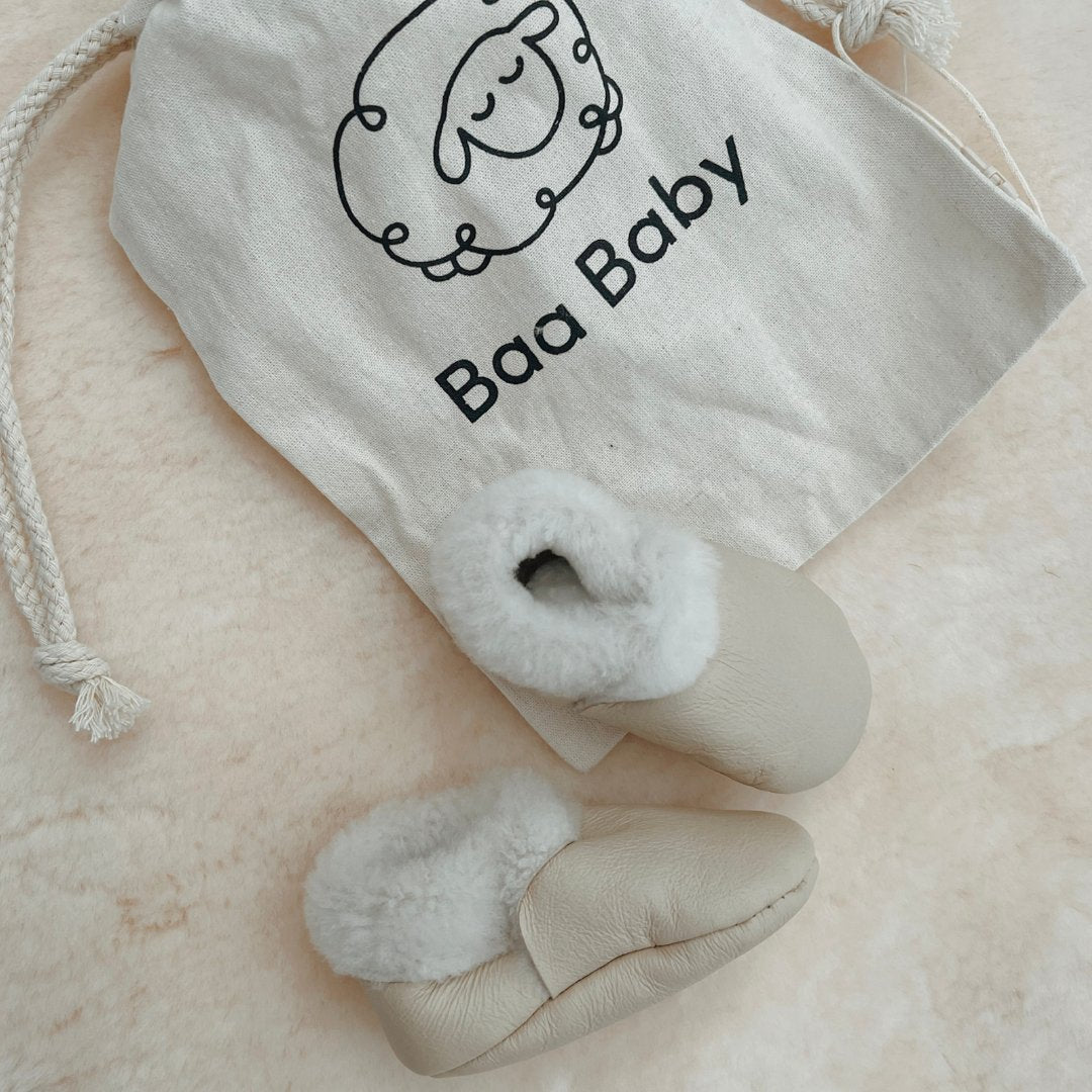 Lambskin baby slipper booties perfect for wriggly feet, soft and supple and natural baby gift in cream nappa 