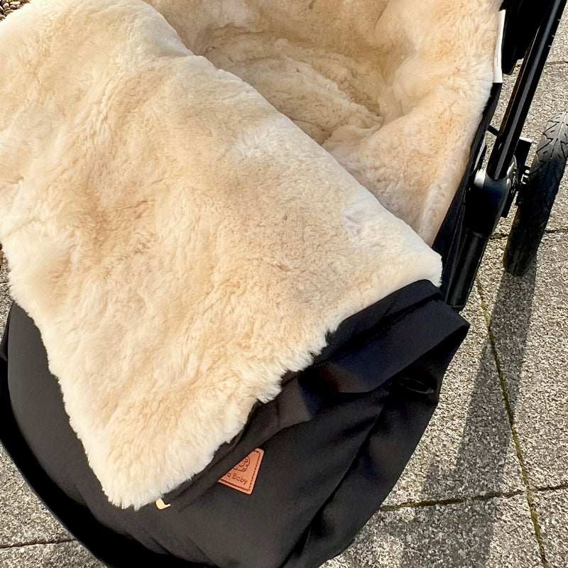 Luxury fully sheepskin lined footmuff compatible with Cybex Priam and Uppababy, shown with top open