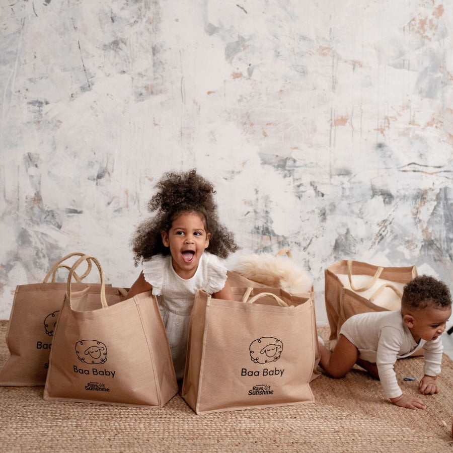 baby safe sheepskin rug and pram liner in a cotton and jute premium shopper bag