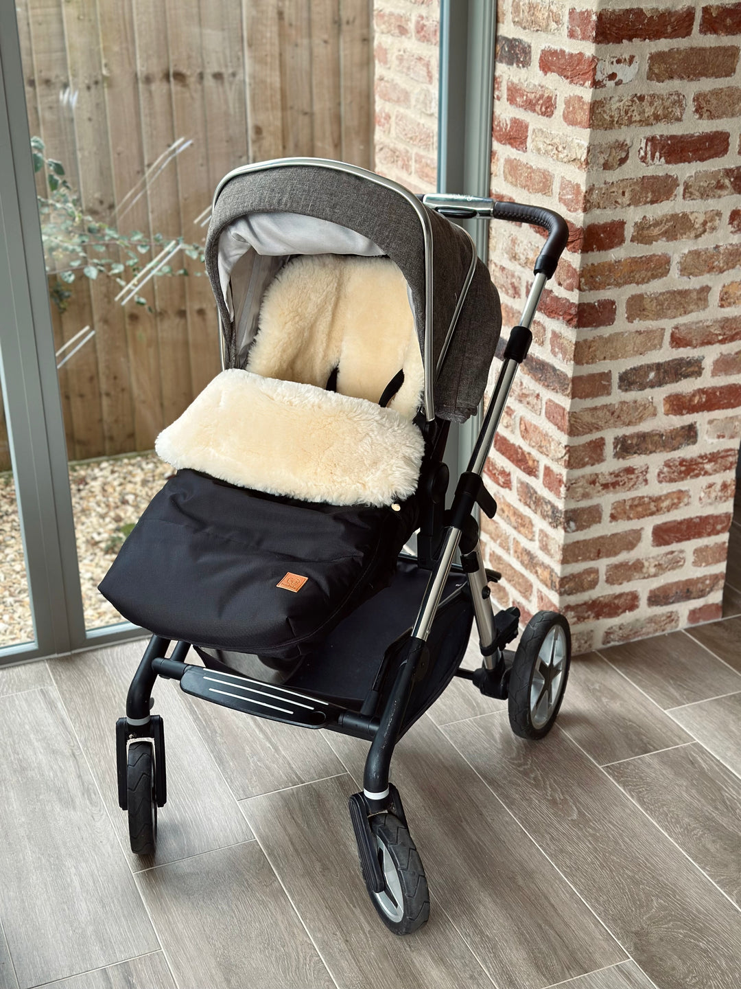 Sheepskin pram footmuff fitted into the silver cross pioner and compatible with the dune, reef and coast strollers