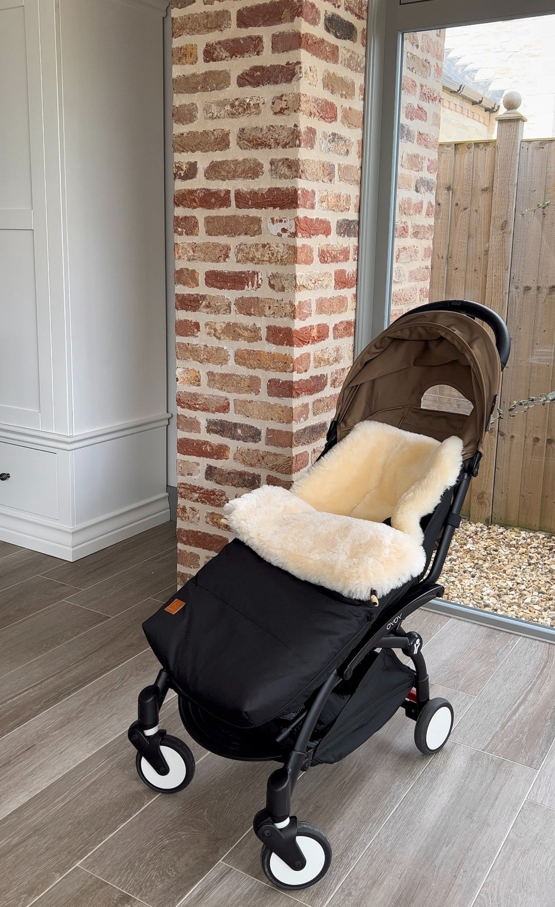 sheepskin footmuff lined with merino, providing breathability, softness and keeping baby warm in winter