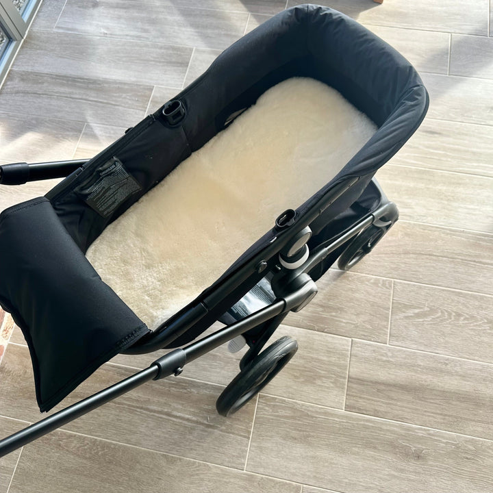 sheeskin carrycot liner in white in a bugaboo fox pram
