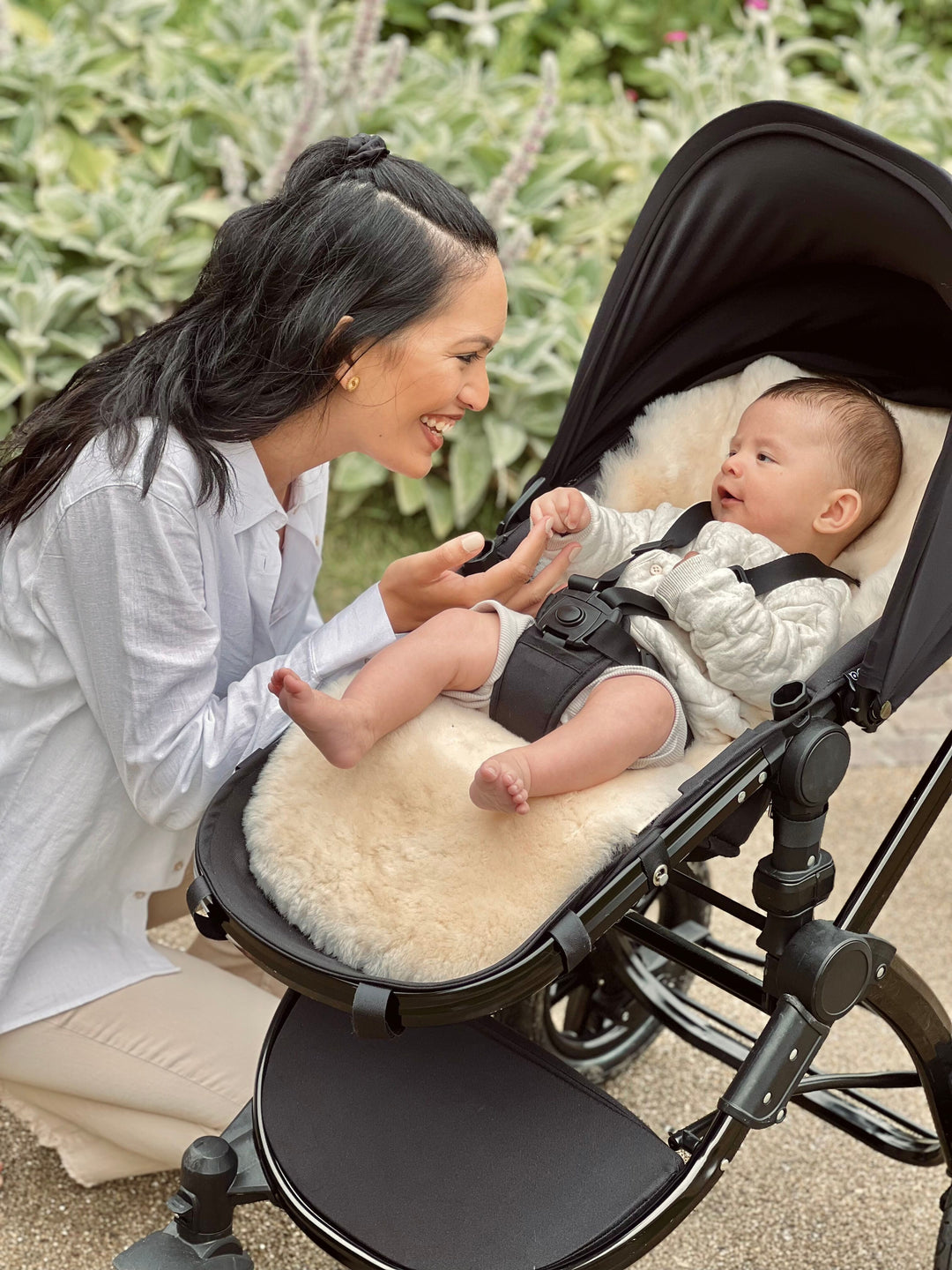 Sheepskin buggy liner in a cybex pram keeping baby cool in summer and helping with sleep in the pram
