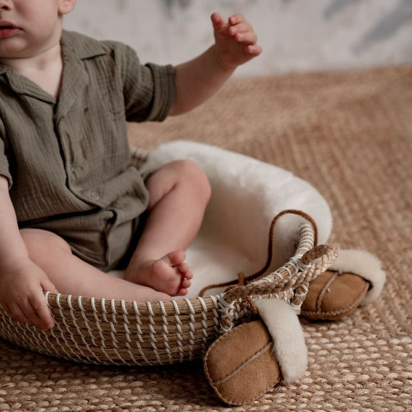 Chestnut coloured mittens on string for babies with a sheepskin lining