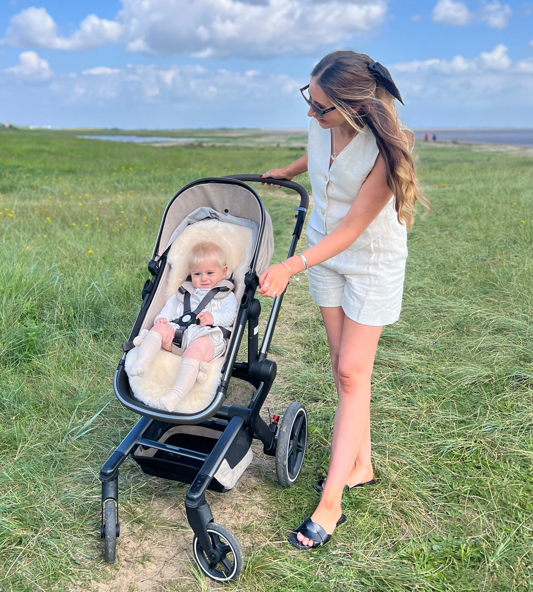 Sheepskin pram liner to keep a baby cool in the spring and summer shown in an egg pram