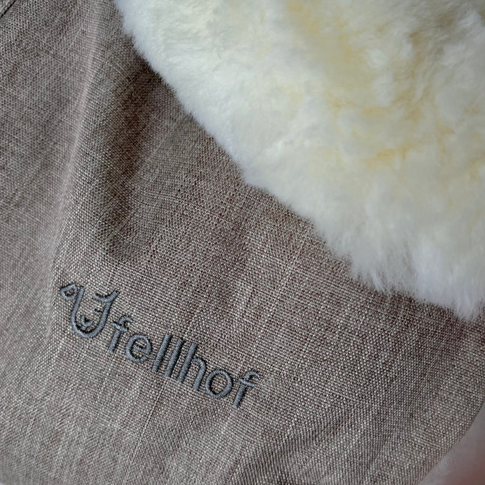 Sheepskin pram handwarmers fully lined with merino luxury buggy mitts to keep your hands warm and stays on the handlebar of the pram
