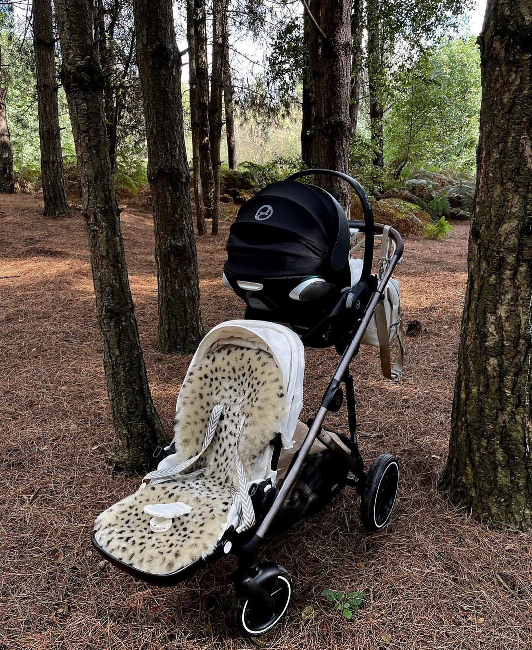 Sheepskin pram liner with leopard print in a cybex duo pram