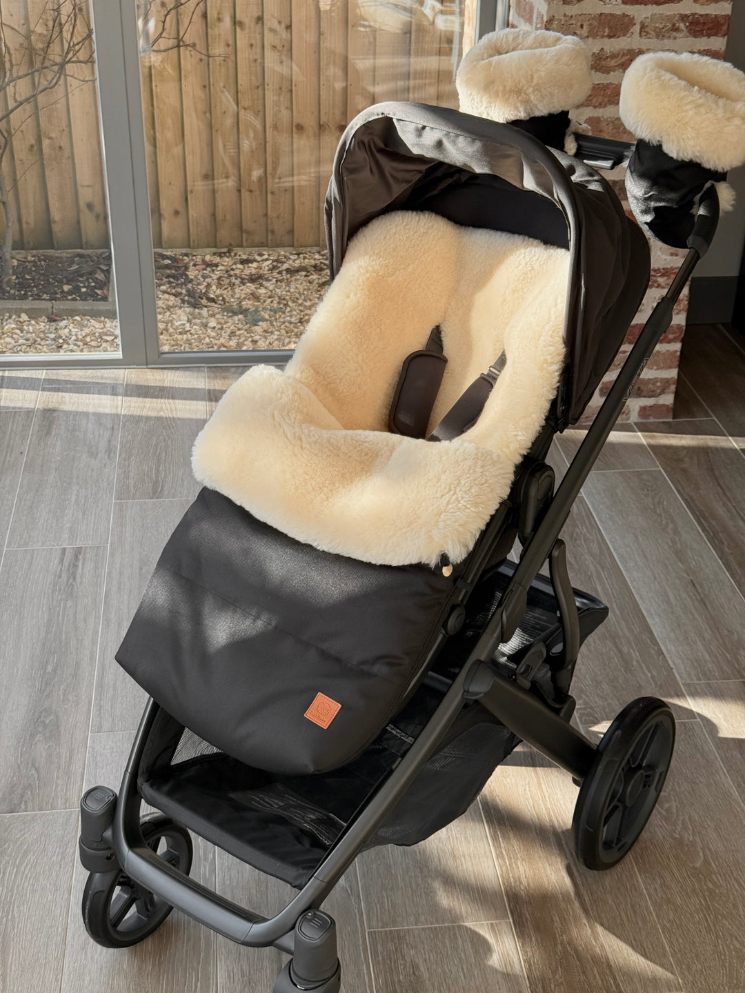 Sheepskin footmuff in the Uppababy Vista V3 with matching hand warmers for the pram