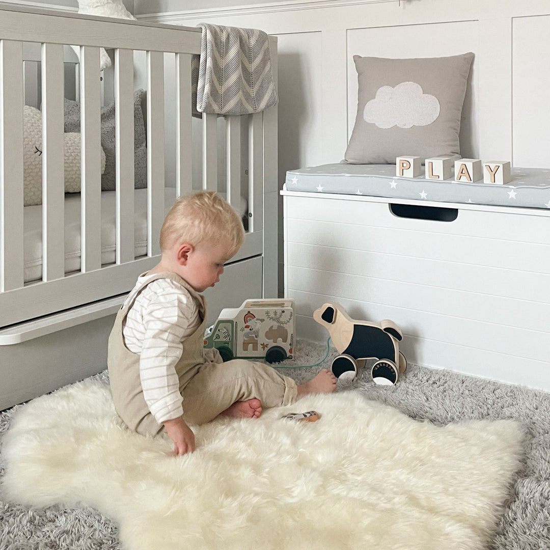 Neutral Baa Baby sheepskin rug in nursery