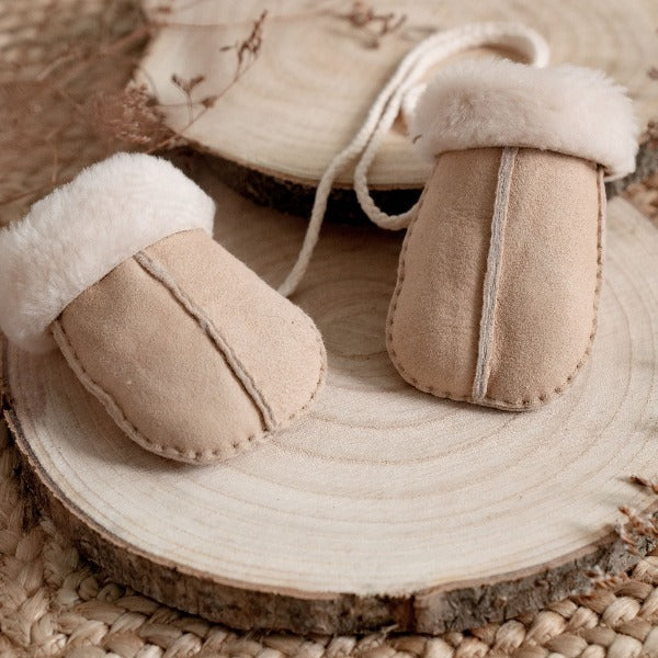 Neutral mittens on string for babies and toddlers