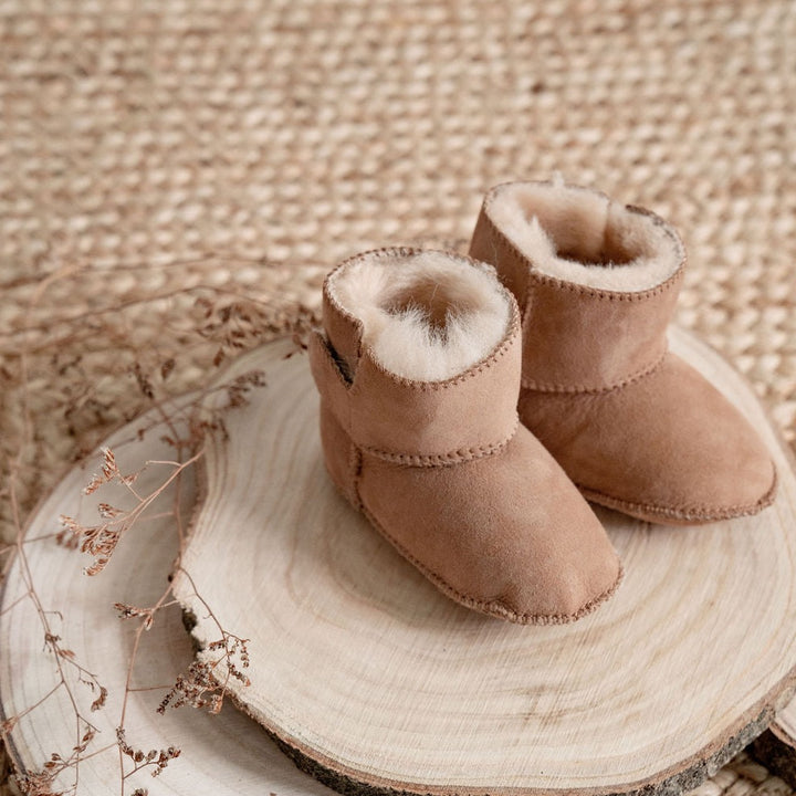 Tabbed booties made from 100% New Zealand Sheepskin, super soft fur on the inside and a suede outer soft sole
