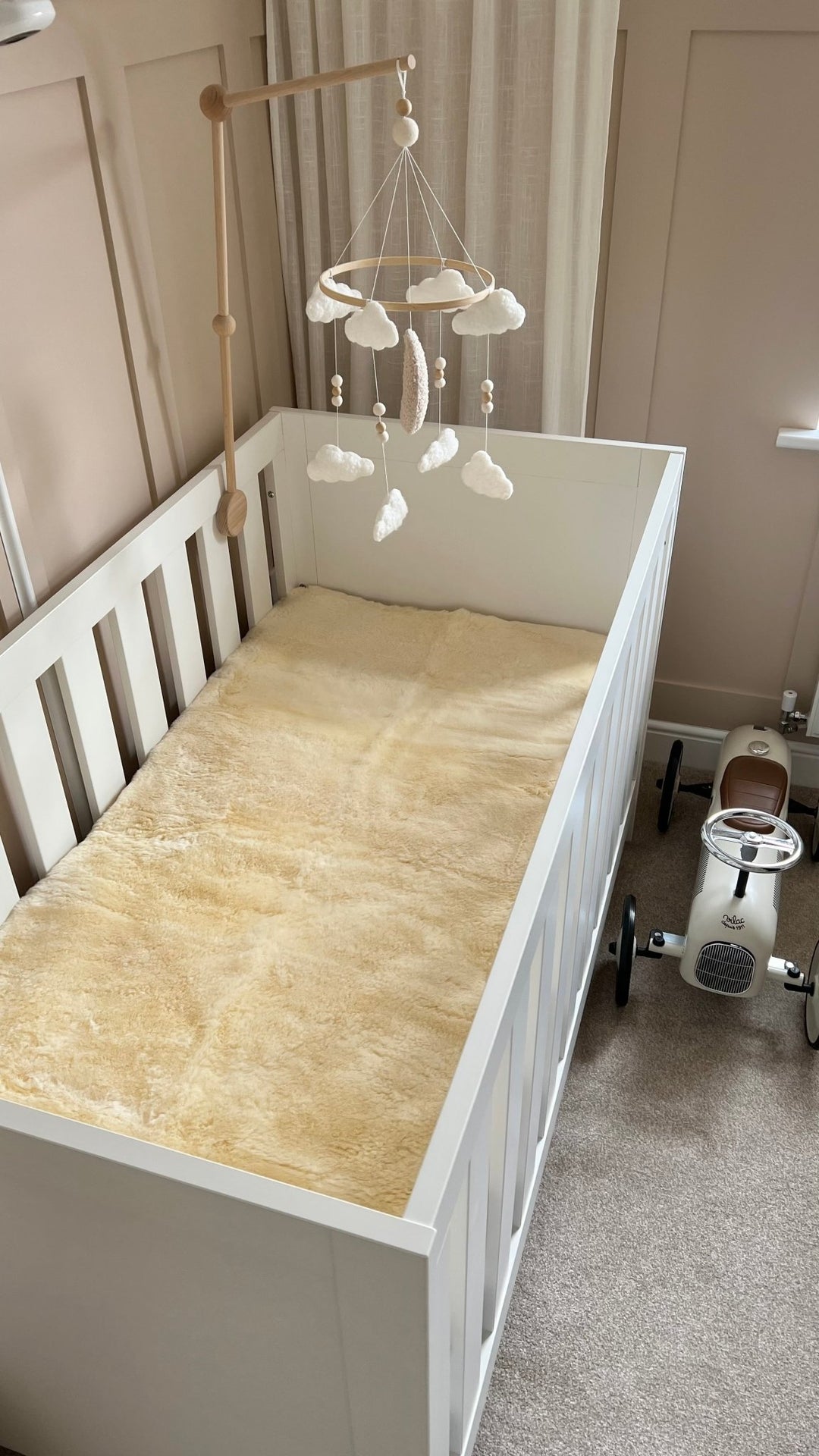 sheepskin mattress cover for a cot or junior bed, bed pad and comforter for a baby crib to help settle baby to sleep