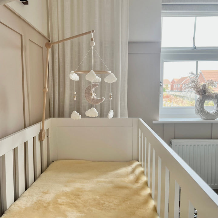 Sheepskin cot topper mattress cover in neutral nursery