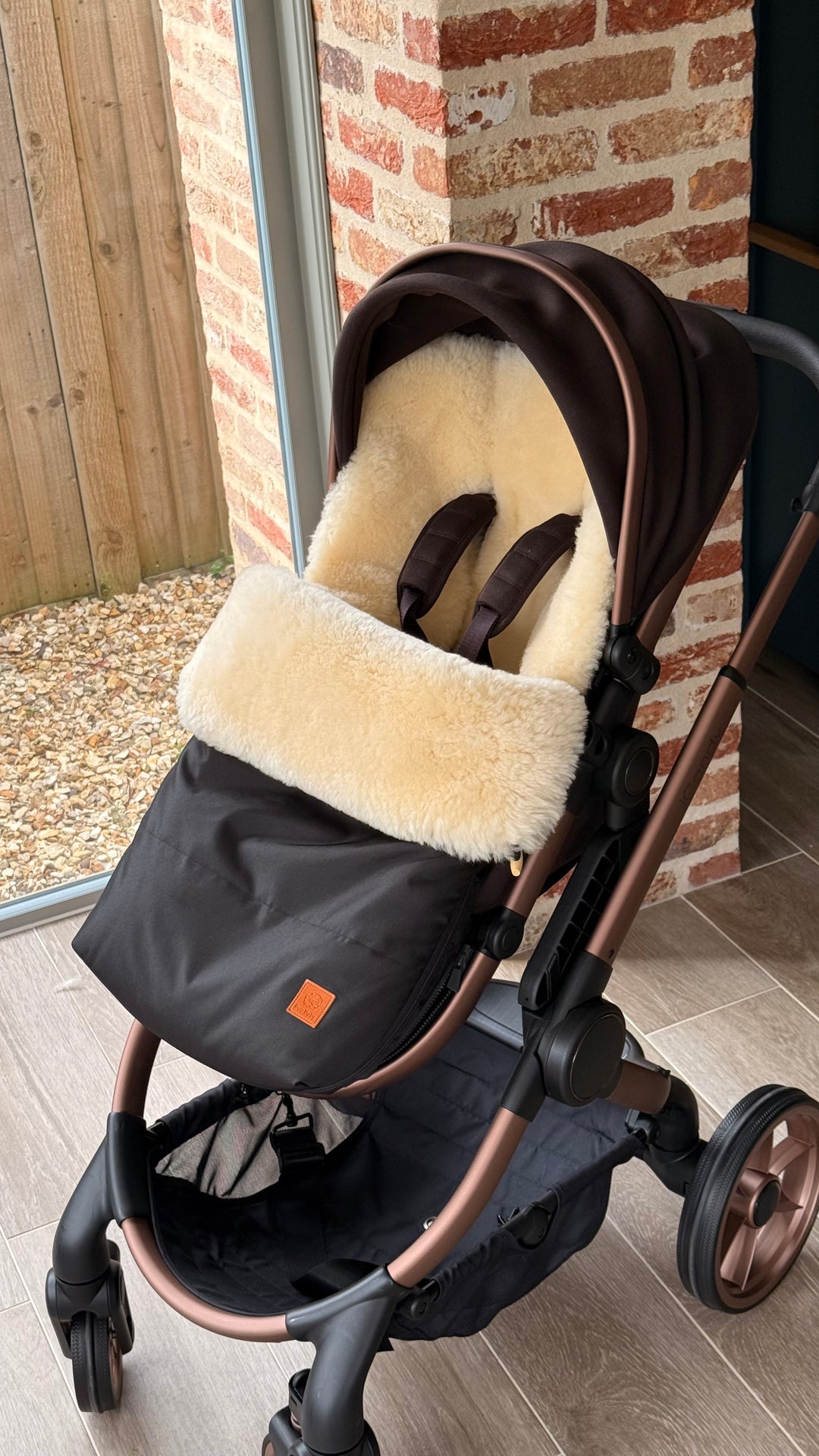 iCandy peach sheepskin footmuff shown in pram 