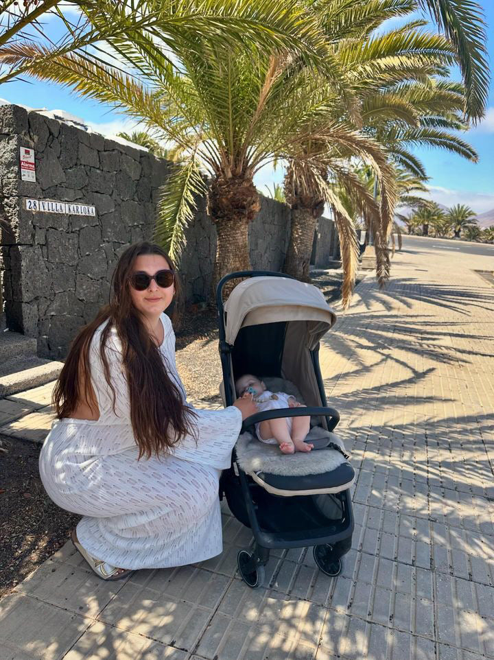 baby asleep in joolz aer pram on holiday with sheepskin liner 