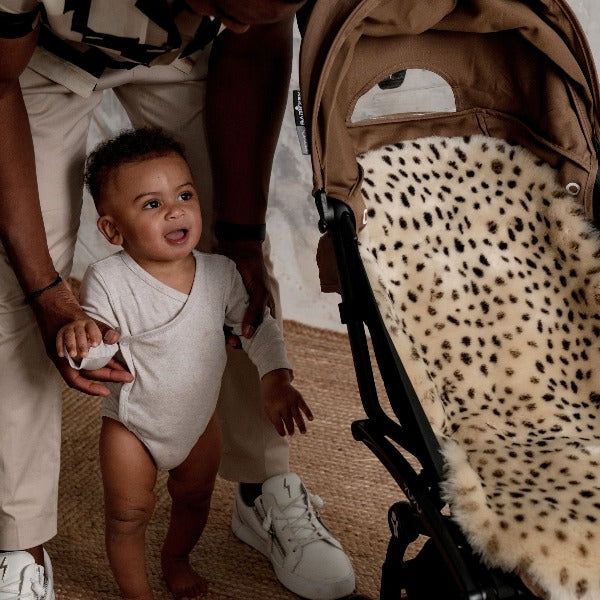 Dad and baby next to a BabyZen YoYo Pram with a Leopard Print Pram Liner