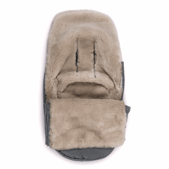 The cosy inside latte sheepskin lining of a footmuff