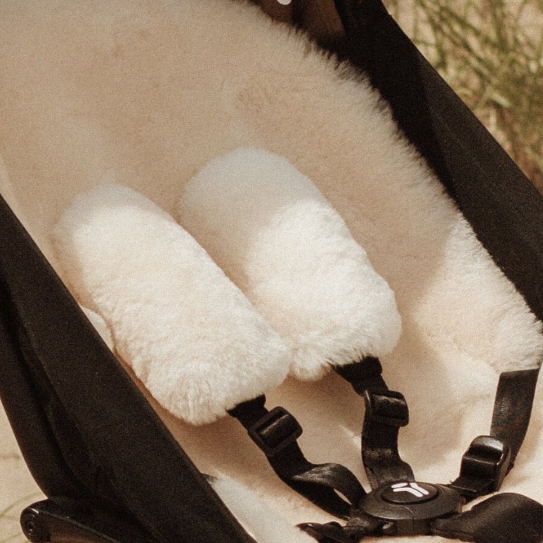 Sheepskin Pram Harness Strap Cover in neutral milk to cushion the straps of a buggy
