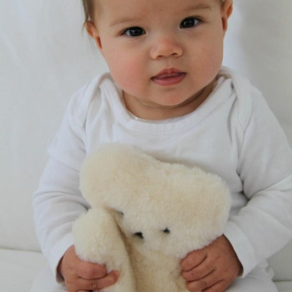 Baby Grabbing FLATOUT Bear in Milk White made from Sustainably Sourced Lambskin