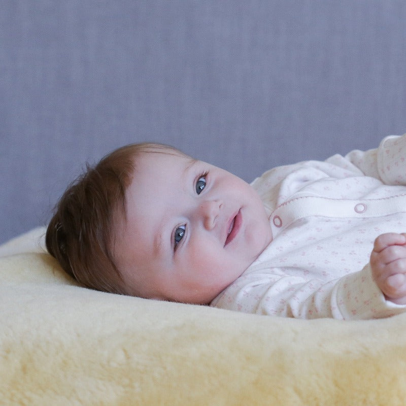Shorn Lambskin with Baby Sleeping for Neutral Nursery Decor