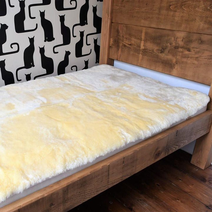 Single Bed with Natural Honey Coloured Sheepskin Mattress Cover 